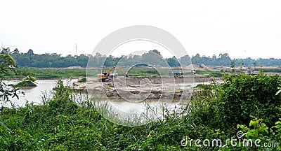 Excavator and truck move soil from reservoir Editorial Stock Photo