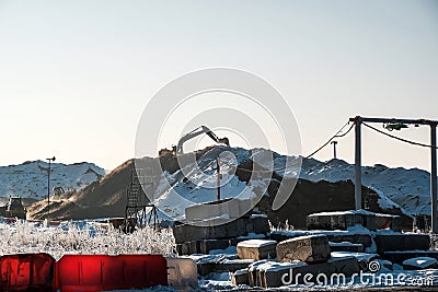 Excavator working on a mountain of sand Editorial Stock Photo