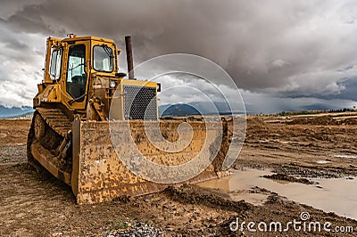 Excavator working on a muddy construction site Stock Photo