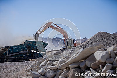Excavator working in quarry with other machines Editorial Stock Photo
