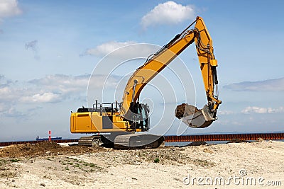 Excavator works on a construction site Stock Photo