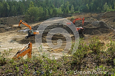 Excavators are developing a sand pit. Stock Photo