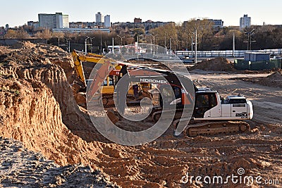 Excavators HIDROMEK, HITACHI and JCB on earthworks at construction site. Backhoe on foundation work and road construction. Tower Editorial Stock Photo
