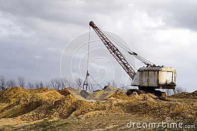 Excavators in the red clay quarry Stock Photo