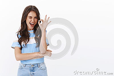 Excellent choice, approve it. Confident attractive european woman with curly haircut wink flirty say alright, show okay Stock Photo