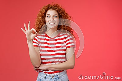 Excellent choice good. Attractive cheerful european redhead curly woman show okay ok approval gesture smiling toothy Stock Photo