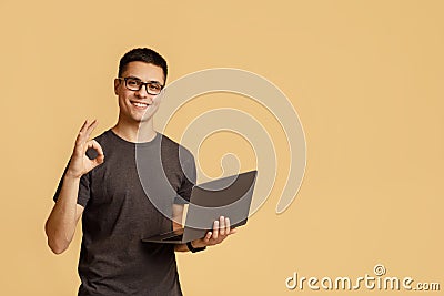Excellent result, good feedback and vin. Smiling male in glasses expresses emotions of success Stock Photo