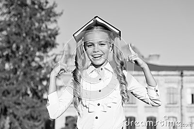 Excellent student girl study with school book outdoors, having fun concept Stock Photo