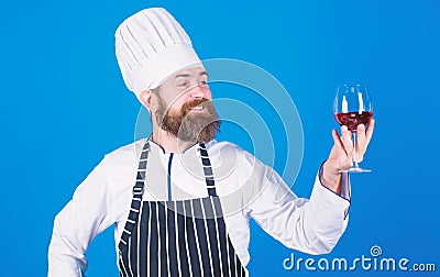 Excellent taste. Chef in cook hat and apron improve sommelier skill. Serving wine at restaurant. Drink alcohol. Hipster Stock Photo