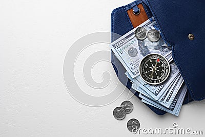 Exchange rate. Wallet with money (dollar banknotes and coins) and compass on white background, top view. Space for text Stock Photo