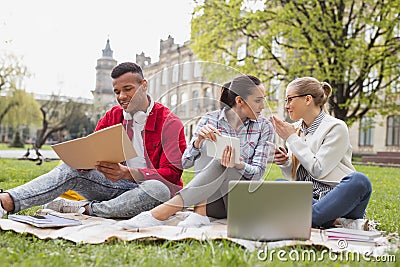 Exchange students chatting with each other spending free time together Stock Photo