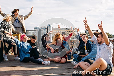 Exchange students singing rooftop together bonding Stock Photo