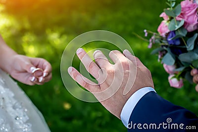 Exchange wedding rings at the wedding, hands close-up Stock Photo