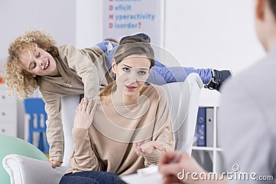 Excitable child and tired mother Stock Photo