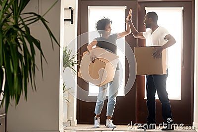 Excited African American couple giving high five, celebrate relocation Stock Photo