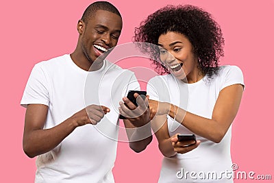 Excited African American couple using mobile phone, reading good news Stock Photo