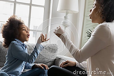 Excited African American kid talking to mom nonverbal Stock Photo