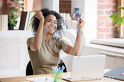 Excited black woman feel euphoric reading god news online Stock Photo