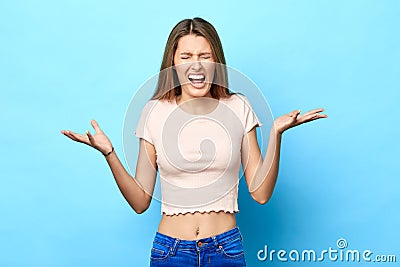 Excited angry nervous girl raised with and closed eyes screaming Stock Photo