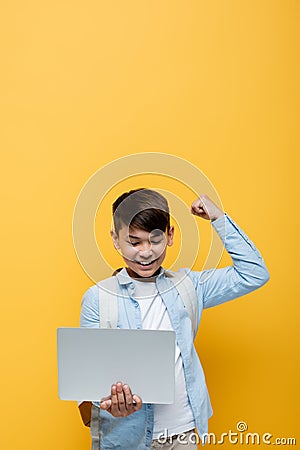 Excited asian schoolkid showing yes gesture Stock Photo