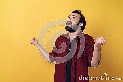 Excited Attractive Bearded Man Clenching Fists Stock Photo