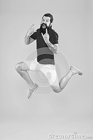 Excited bearded man jumping. full of energy. Impetuous movement. dedicated to sport and fitness. active runner in move Stock Photo