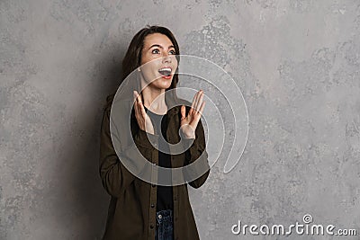 Excited beautiful brunette girl expressing surprise at camera Stock Photo