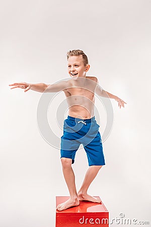 excited boy pretending to be a surfer Stock Photo