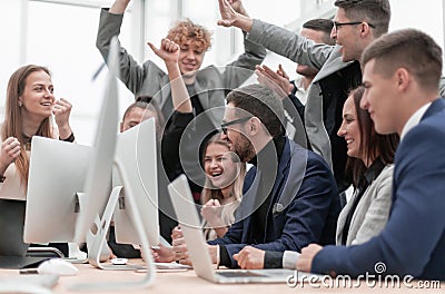 Excited business team is jubilant in the workplace. Stock Photo