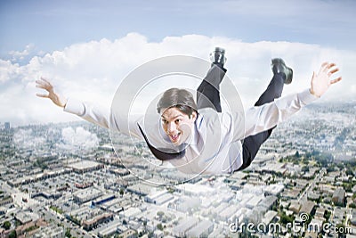 Excited Businessman Flying In The Clouds Stock Photo
