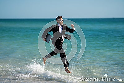 Excited businessman in wet suit run in sea. Funny business man, crazy comic business concept. Remote online working Stock Photo
