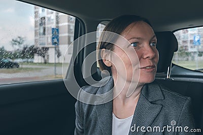Excited businesswoman at back seat of a car Stock Photo