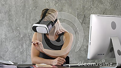 Excited businesswoman wearing virtual reality glasses, happy woman exploring augmented world, interacting with digital Stock Photo