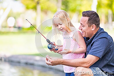 Excited Caucasian Father and Daughter Having Fun Fishing At The La Stock Photo