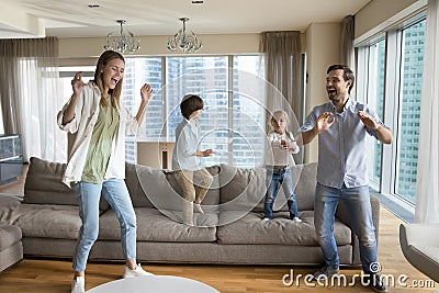 Excited cheerful active parents and little sibling kids having fun Stock Photo