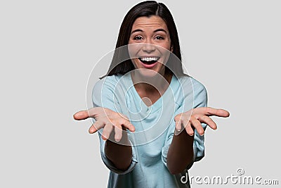 Excited, cheerful, happy, joyful woman with palms up, hands out, possibly winning and holding a gift, receiving a prize, isolated Stock Photo
