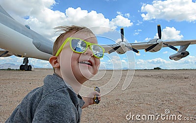 Excited child and airplane at airport Stock Photo