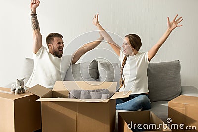 Excited couple glad to move into new home celebrating together Stock Photo