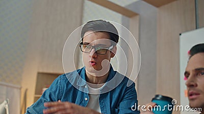 Excited creators discussing computer project office. Eyeglasses man gesturing Stock Photo