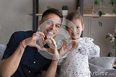 Excited dad and girl making hand hearts at camera Stock Photo