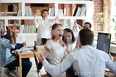 Excited diverse business team employees screaming celebrating good news success Stock Photo