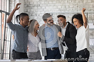 Excited diverse colleagues celebrating teamwork success, business achievement Stock Photo