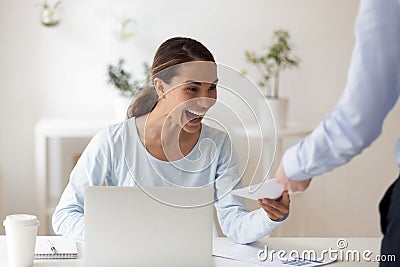 Excited employee receiving from boss envelope with money Stock Photo