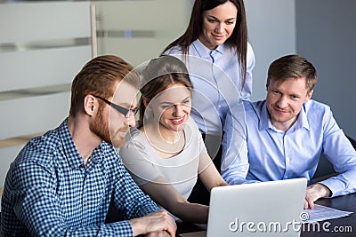 Excited employees looking at laptop observing growing statistics Stock Photo