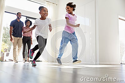 Excited Family Exploring New Home On Moving Day Stock Photo