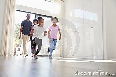 Excited Family Exploring New Home On Moving Day Stock Photo