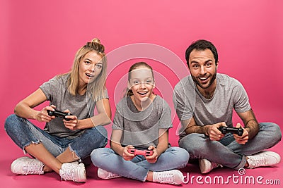 excited family playing video game with joysticks, isolated Stock Photo