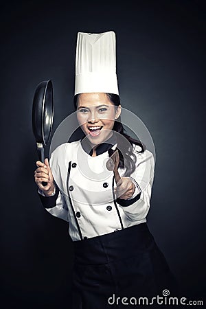 Excited female chef or baker ready to cook Stock Photo