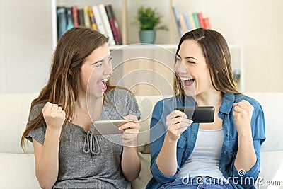 Excited friends playing online game and winning Stock Photo