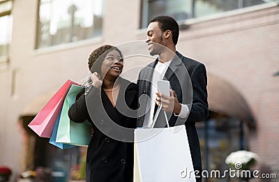 Excited friends using smartphone, shopping online on Black Friday and expresses happy Stock Photo